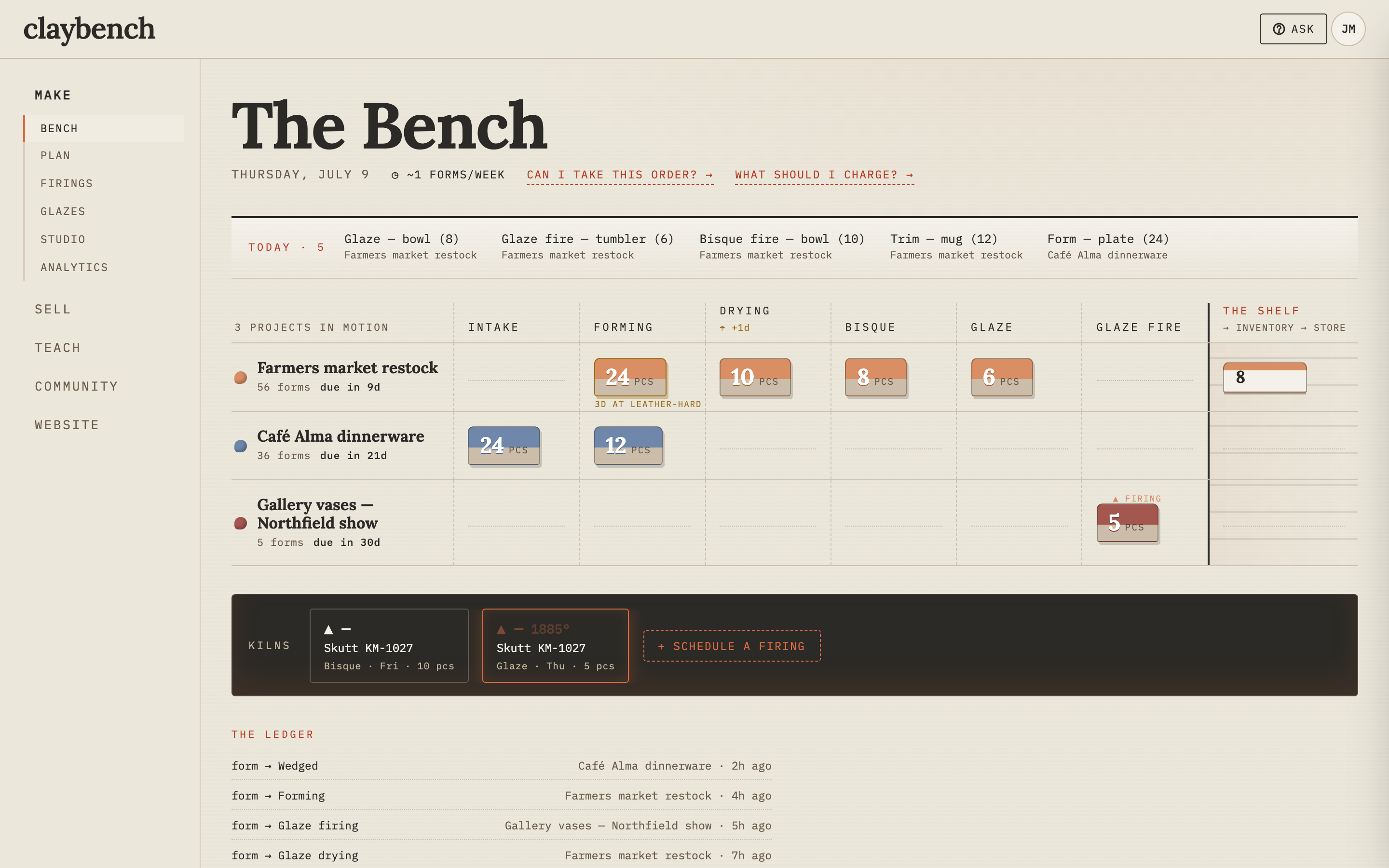 The Bench: a production board with three projects in motion across forming, drying, bisque and glaze — a kiln firing live at 1,885°F on the kiln rail